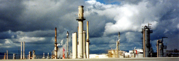 Oil refinery with many smoke stacks and smoke