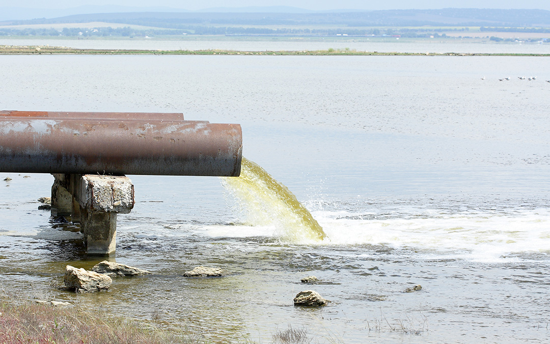 pipe pouring waste water into the ocean